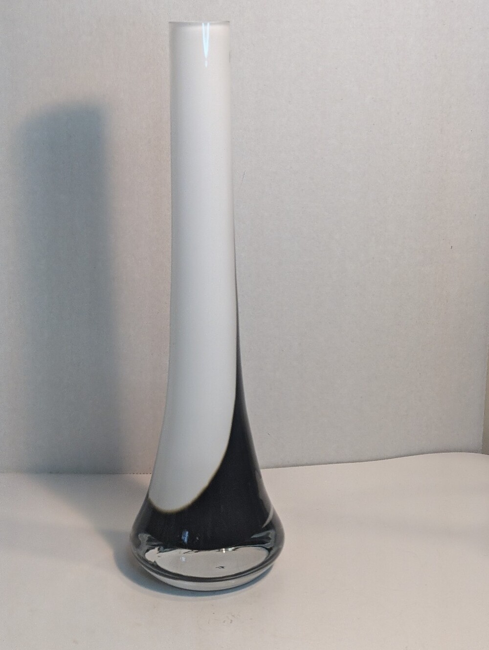 A Polish Art Glass vase from the 1980s, features a tall, slender design.